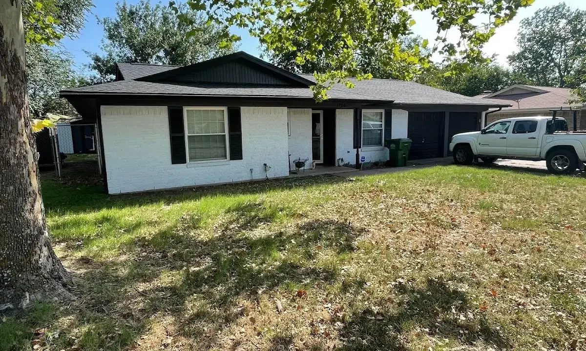 Professional roofing crew working on a residential roof in Belen